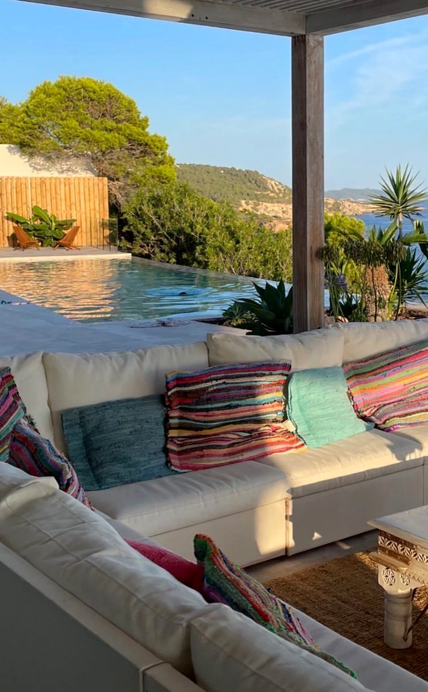 Bright soft sofa adds a clear layer of softness, helping the composition feel open and lived-in.