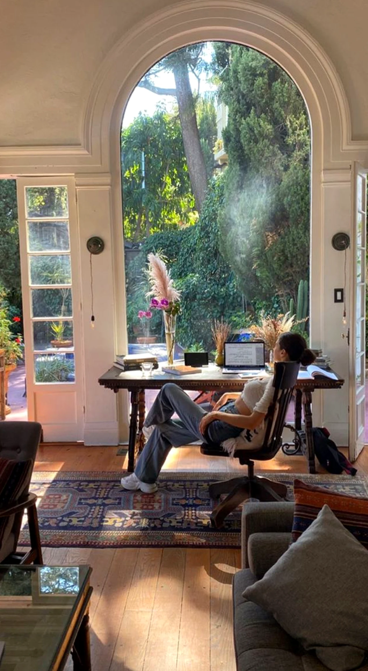Quiet woven chair draws attention to light while the entry stays open and lived-in.