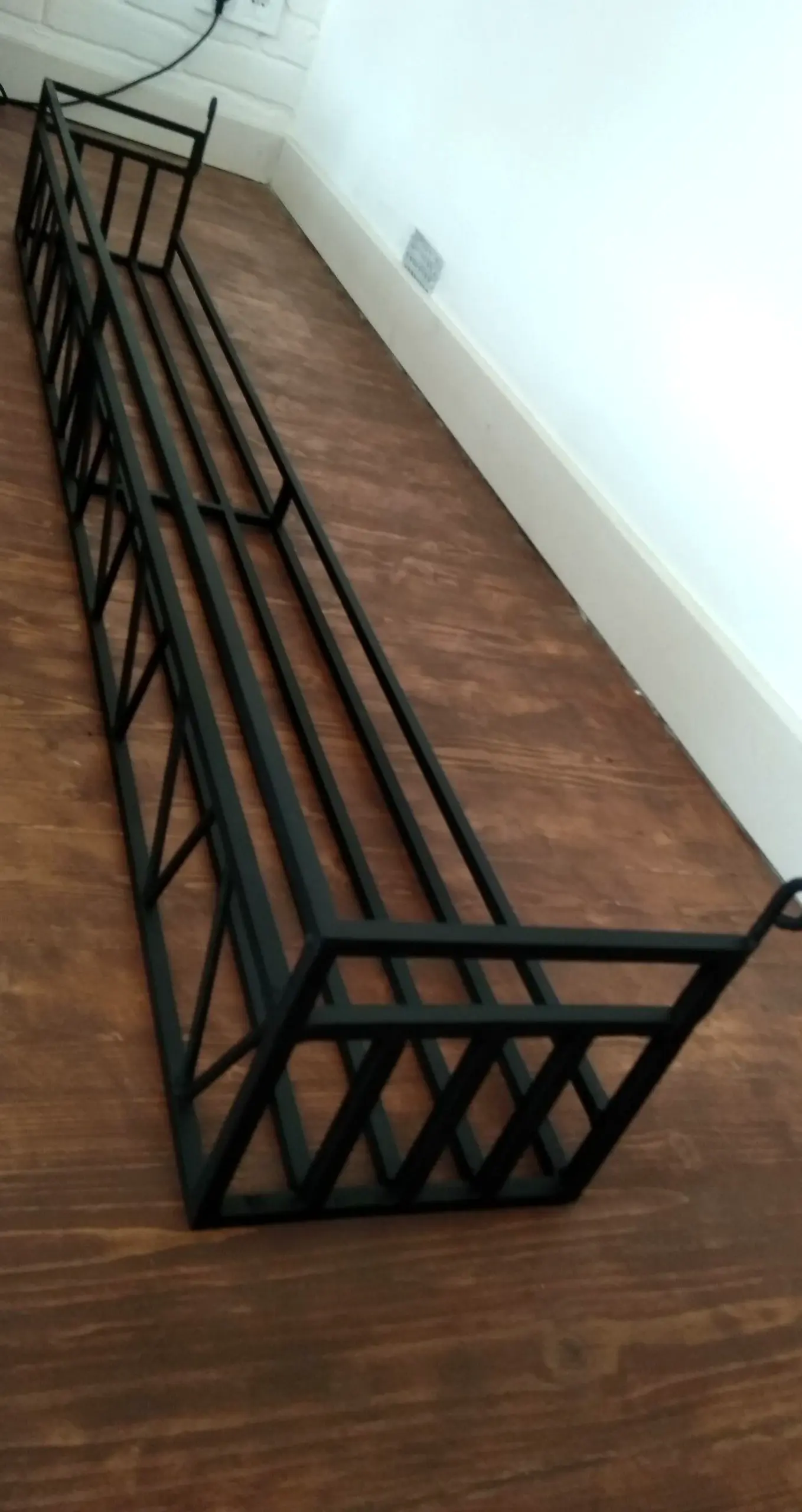 Compact plant shelf gives the wall more depth, so the whole view feels settled and welcoming.