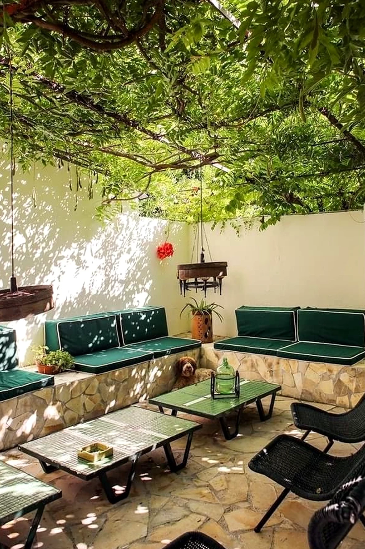 Inviting reading corner brings personality to the garden edge, creating a mood that feels visually grounded.